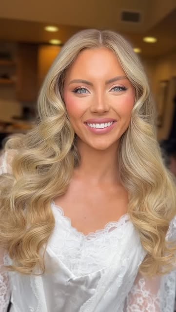Bride with polished blonde waves and luminous makeup