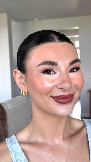 Finished bridal makeup with sleek hair and a deep rose lip