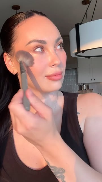 Makeup artist blending a soft luminous bridal complexion
